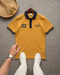 Mustard yellow Brooklyn polo t-shirt with navy blue collar and number 23 embroidery